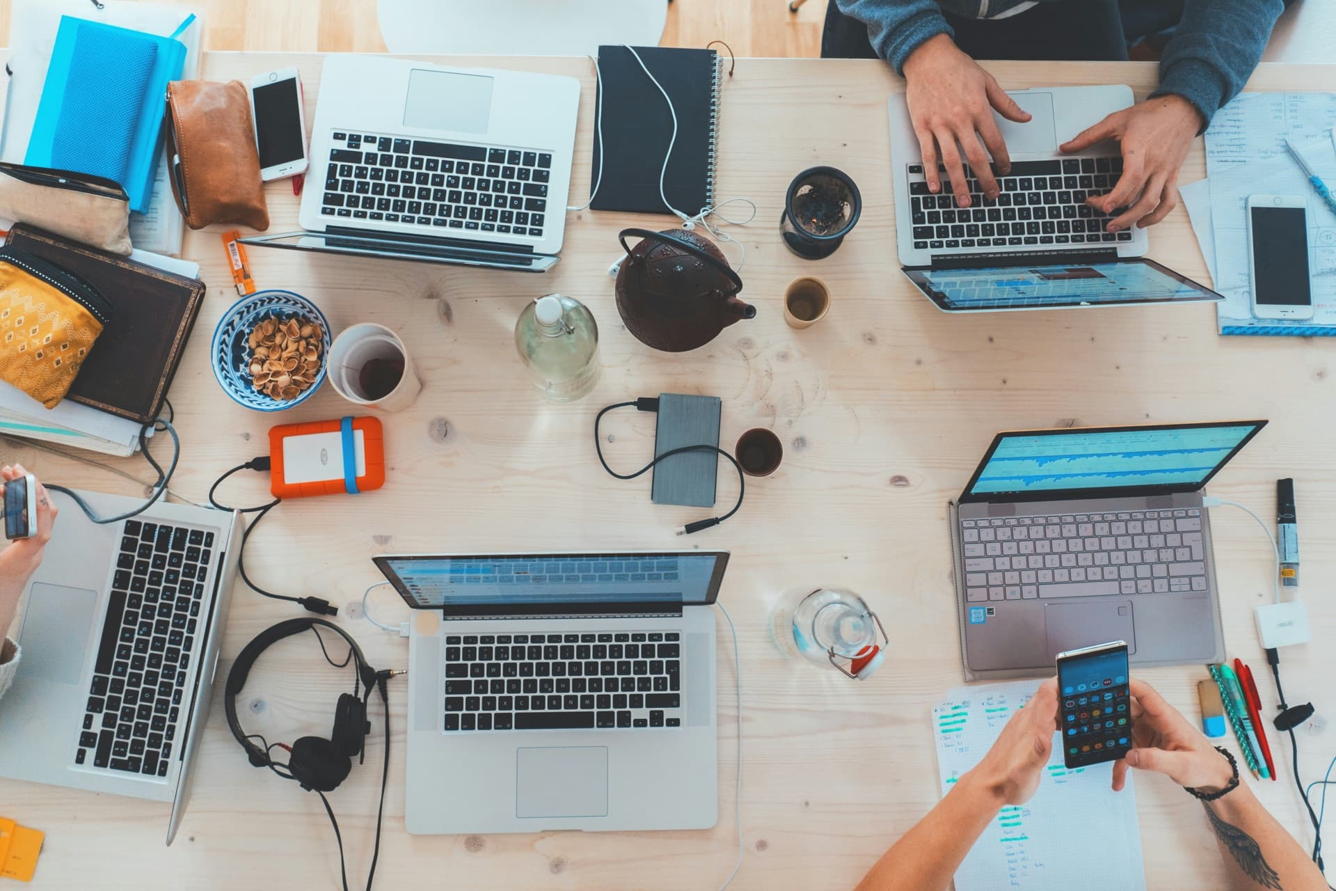 Laptops, notes and phones across a shared desk at the York Coders studio in Selden, NY